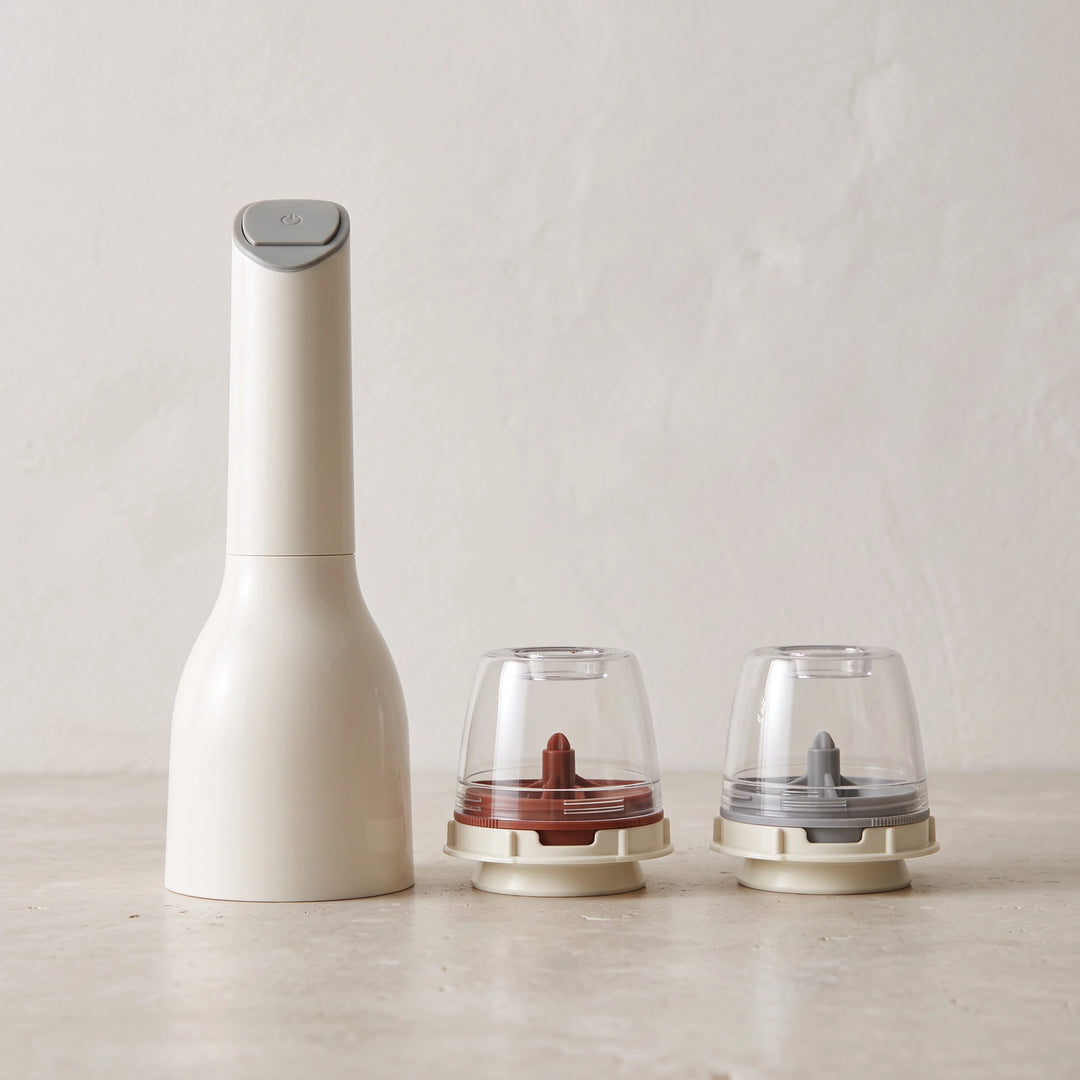 White electric spice mill with two empty pods