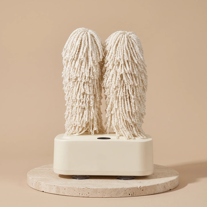 Cream glass polisher with two chenille microfiber brushes on a travertine plinth