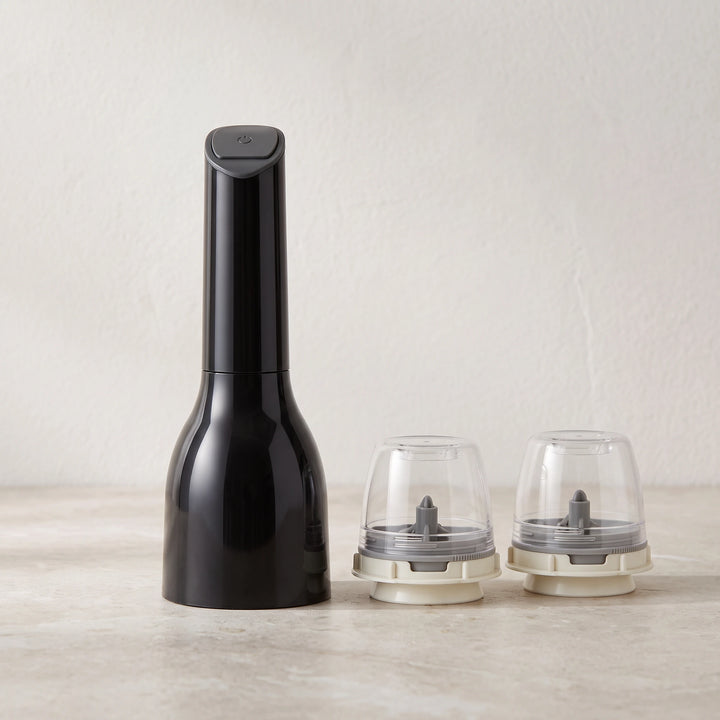 Black electric spice mill with two empty pods