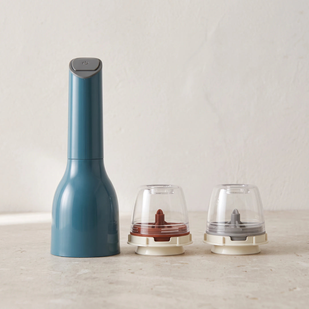 Blue electric spice mill with two empty pods