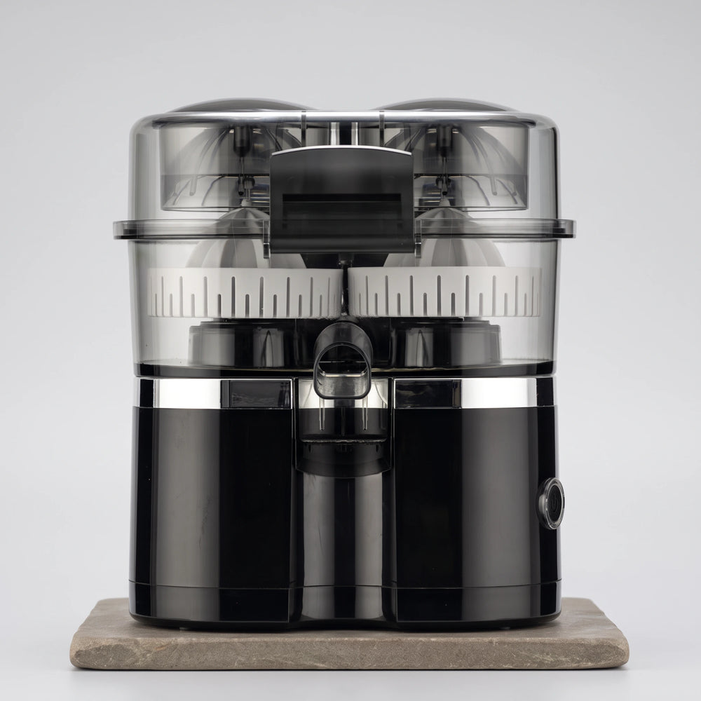 Black dual-head electric citrus juicer with clear lid and silver band