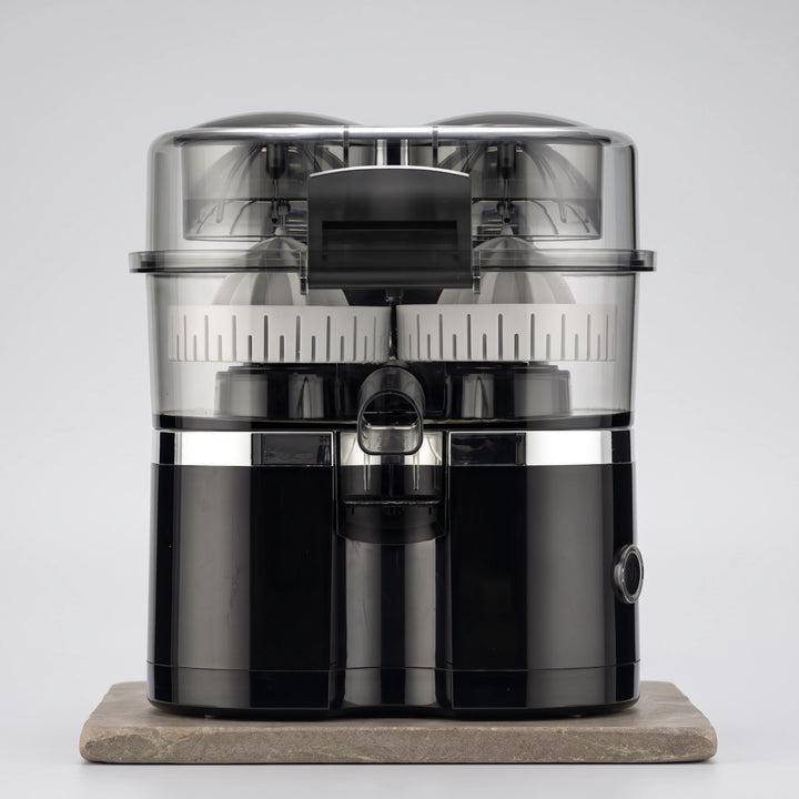 Black dual-head electric citrus juicer with clear lid and silver band