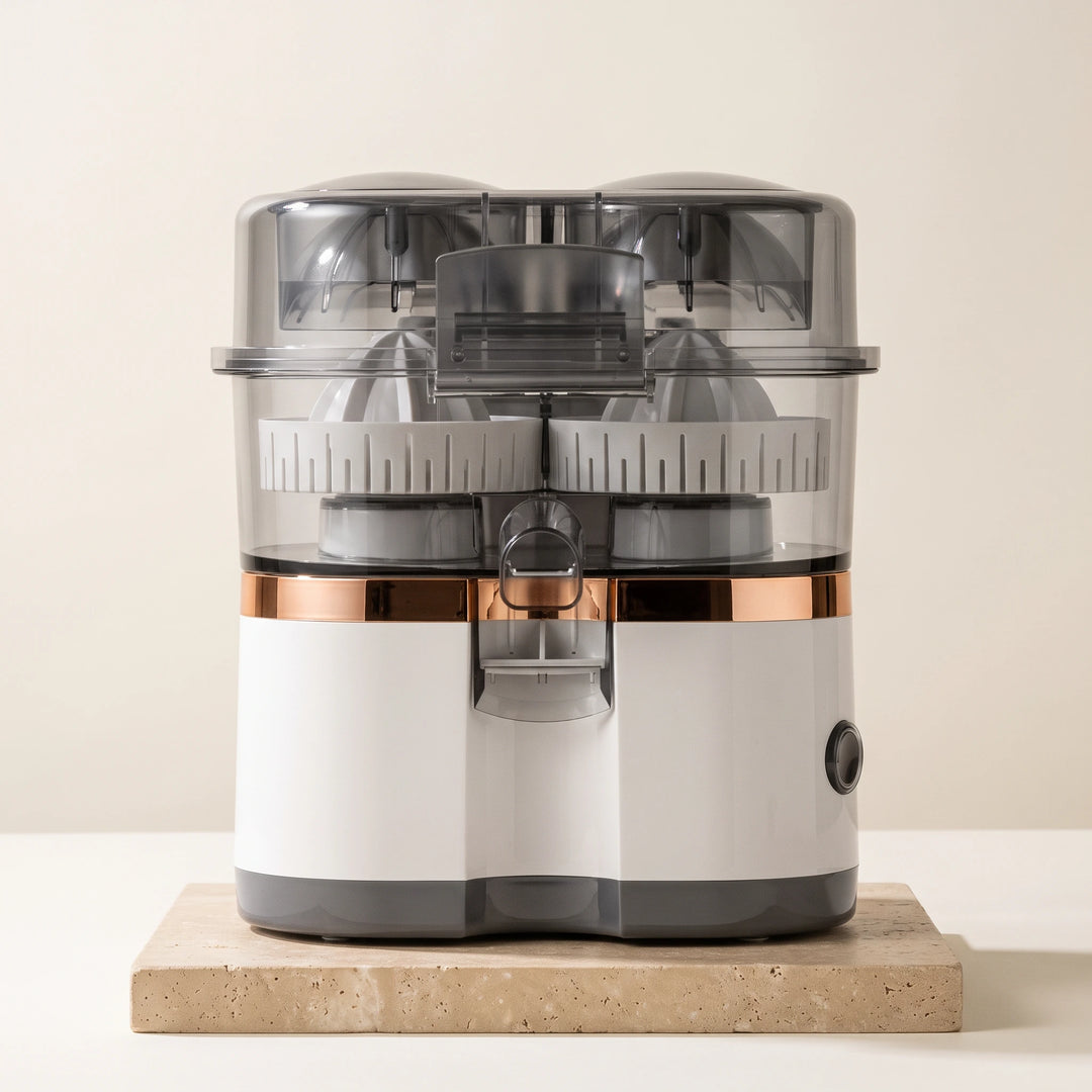 White dual-head electric citrus juicer with clear lid and copper band