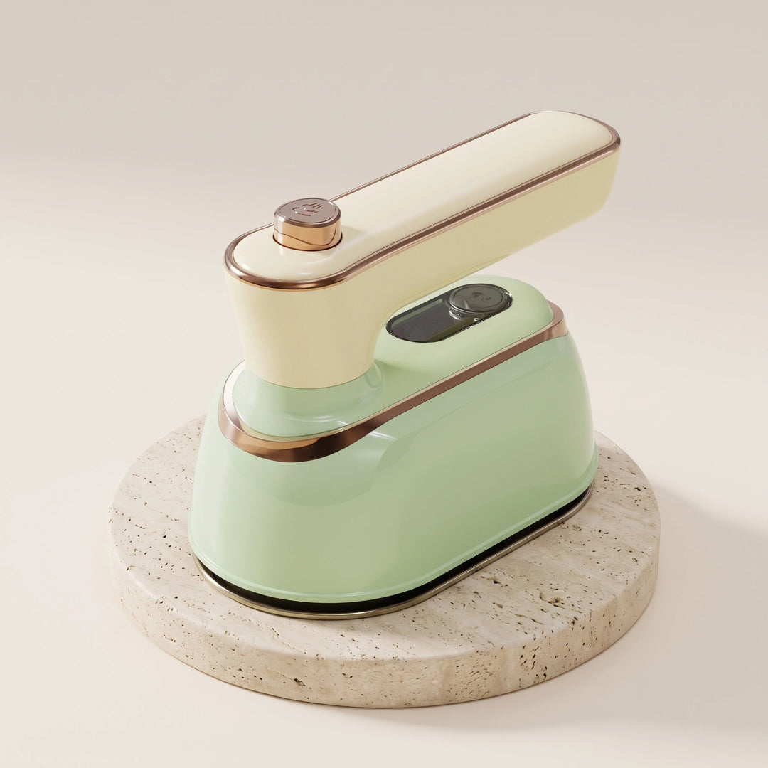 Light fir green handheld steam iron with cream handle