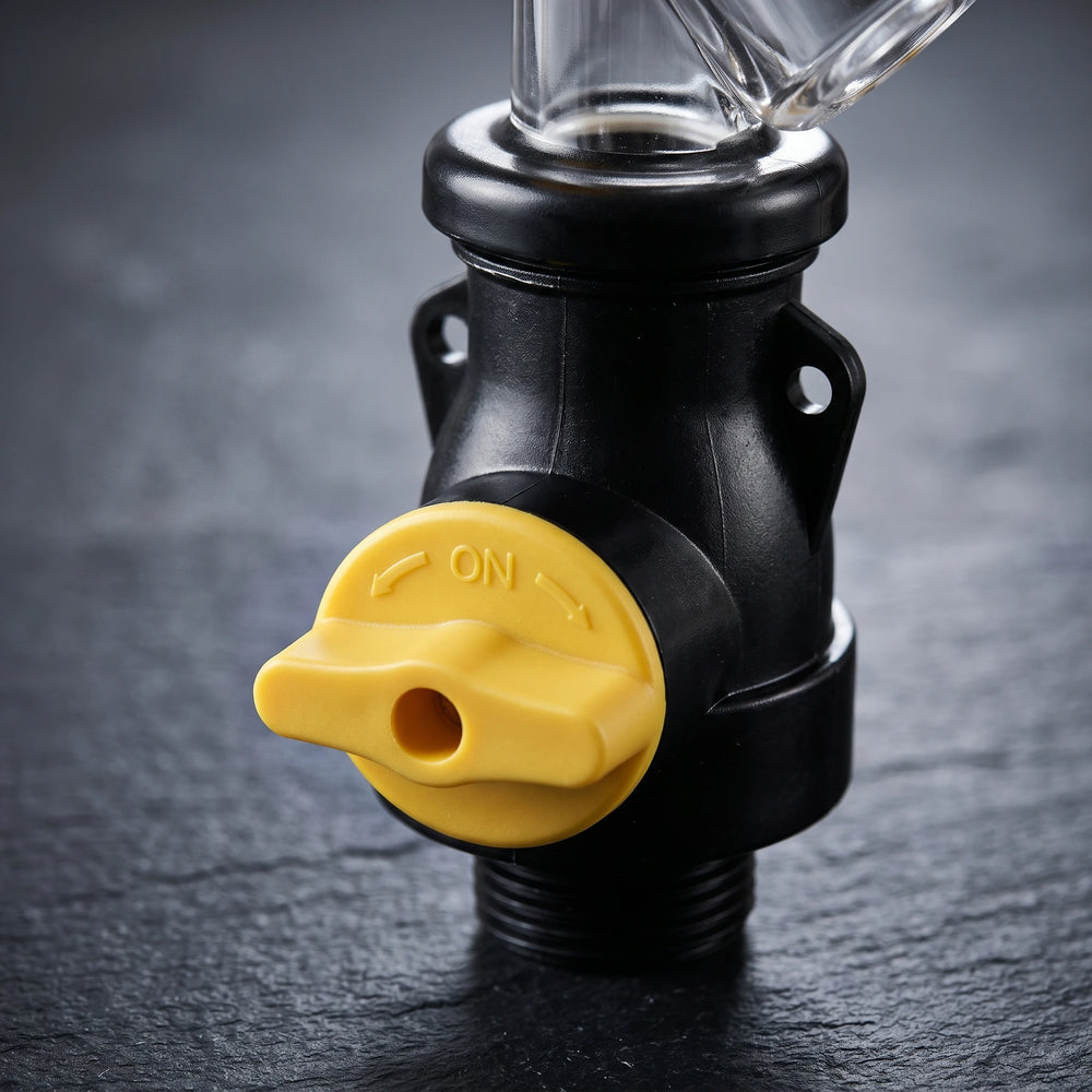 Close-up of the yellow ON paddle valve and black base of the flushing tool